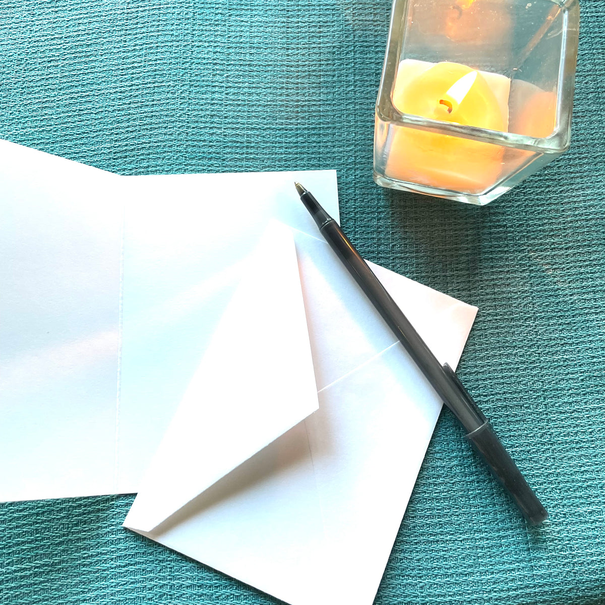 Blank‑inside autumn leaf notecard by Katie Weaver displayed with a pen and candle