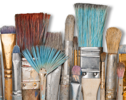 artist paint brushes lined up with turquoise, yellow and red paint in the bristles