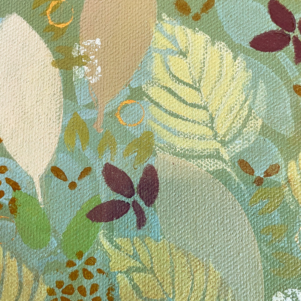 Close-up detail of a small autumn leaf painting by Katie Weaver in warm fall tones.