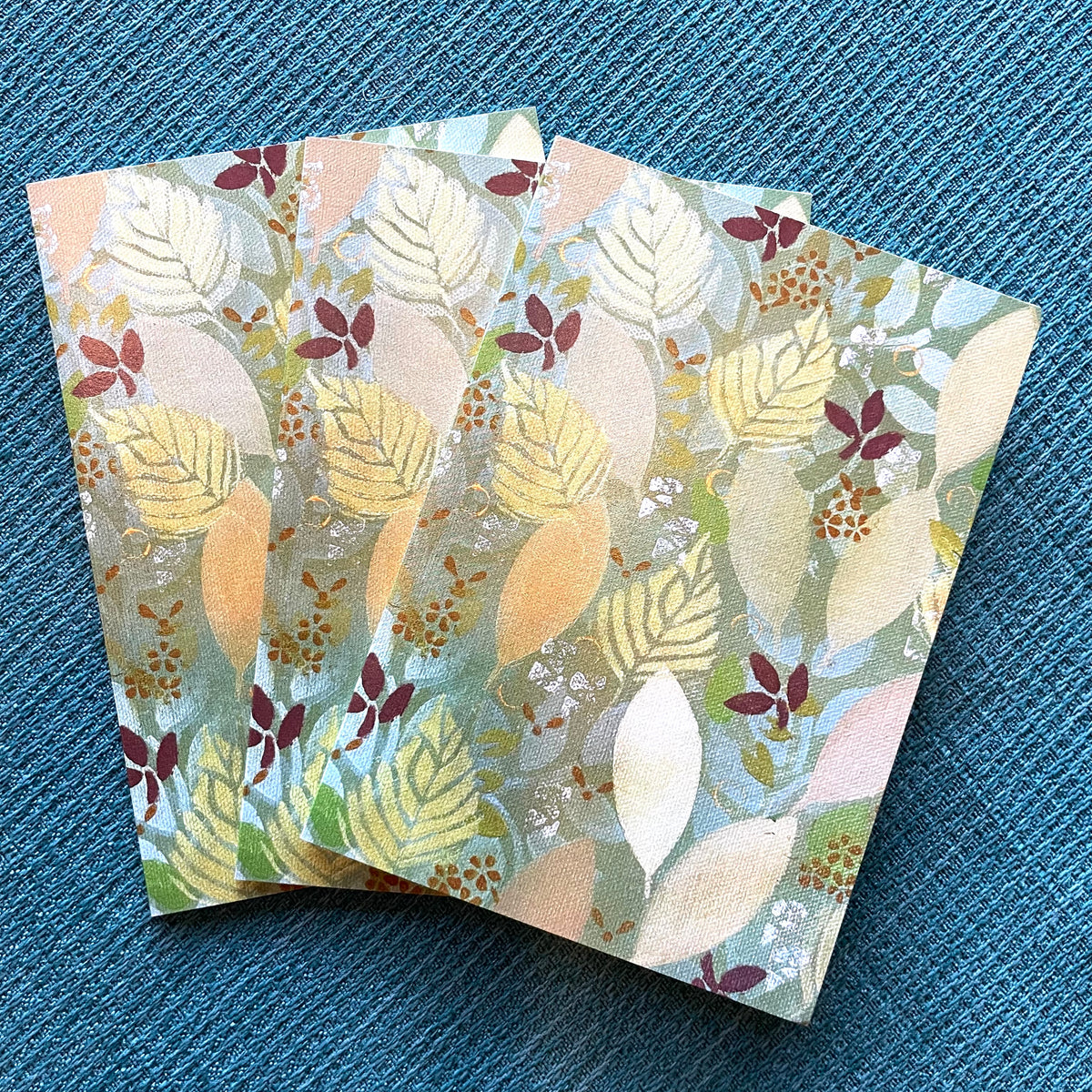 Patterned holiday leaf notecards featuring warm autumn leaf artwork by Katie Weaver.