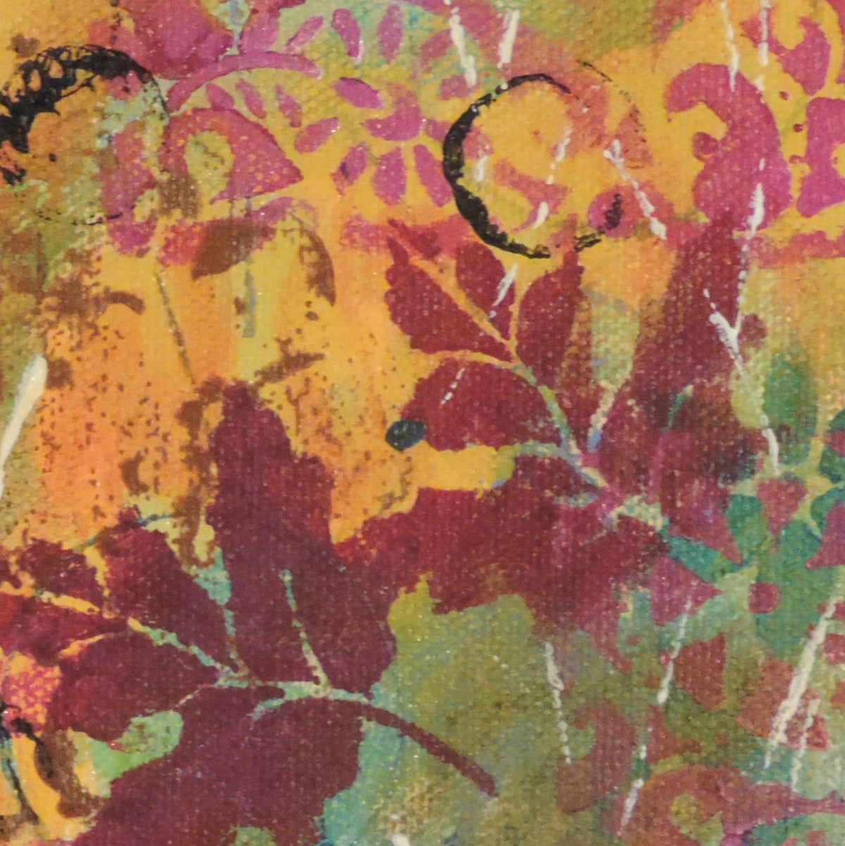 Detail view of a small patterned maple leaf painting by Katie Weaver featuring dark red leaves on an orange and green background.