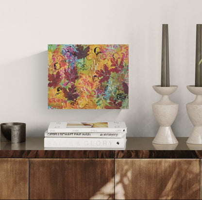 Small patterned maple leaf painting by Katie Weaver displayed in an elegant dining room. 