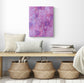 abstract acrylic painting on canvas pink background large purple flowers white leaves red small flowers white squiggles warm and cheerful feeling of love shown in room with bench and baskets below