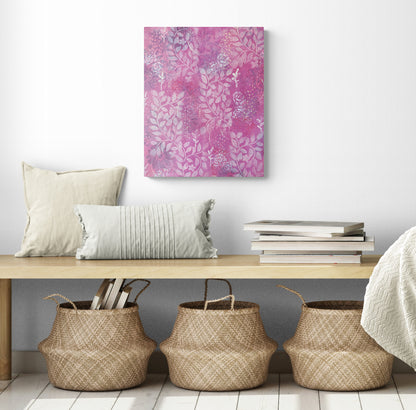 original abstract painting on canvas with warm pink background white roses and leaf prints dark flowers layered underneath emits warm feeling of love shown in room with bench and baskets below