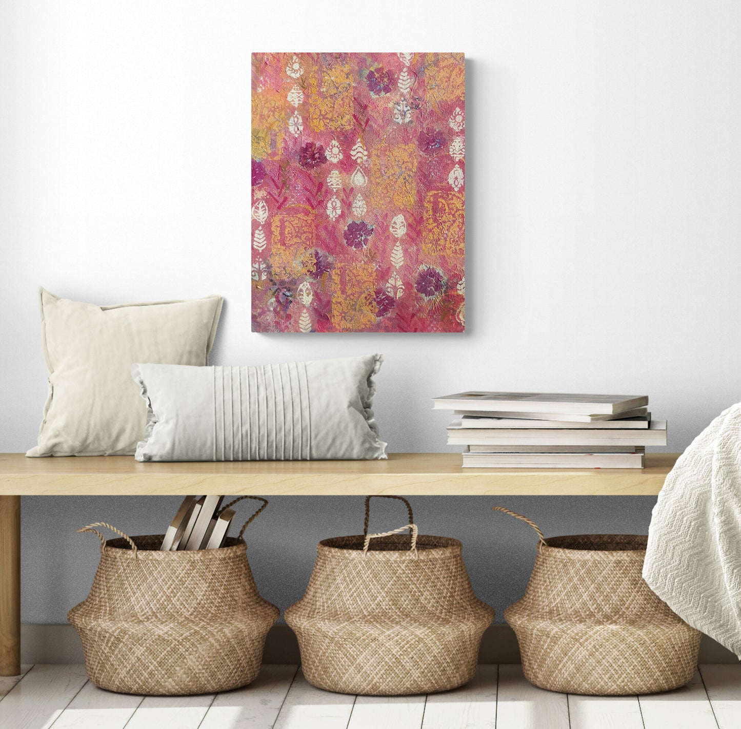 Abstract acrylic painting with red flowers orange and cream shapes in a room with a bench and baskets underneath