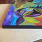 Side view of Abstract Acrylic painting of house and trees orange red green blue purple